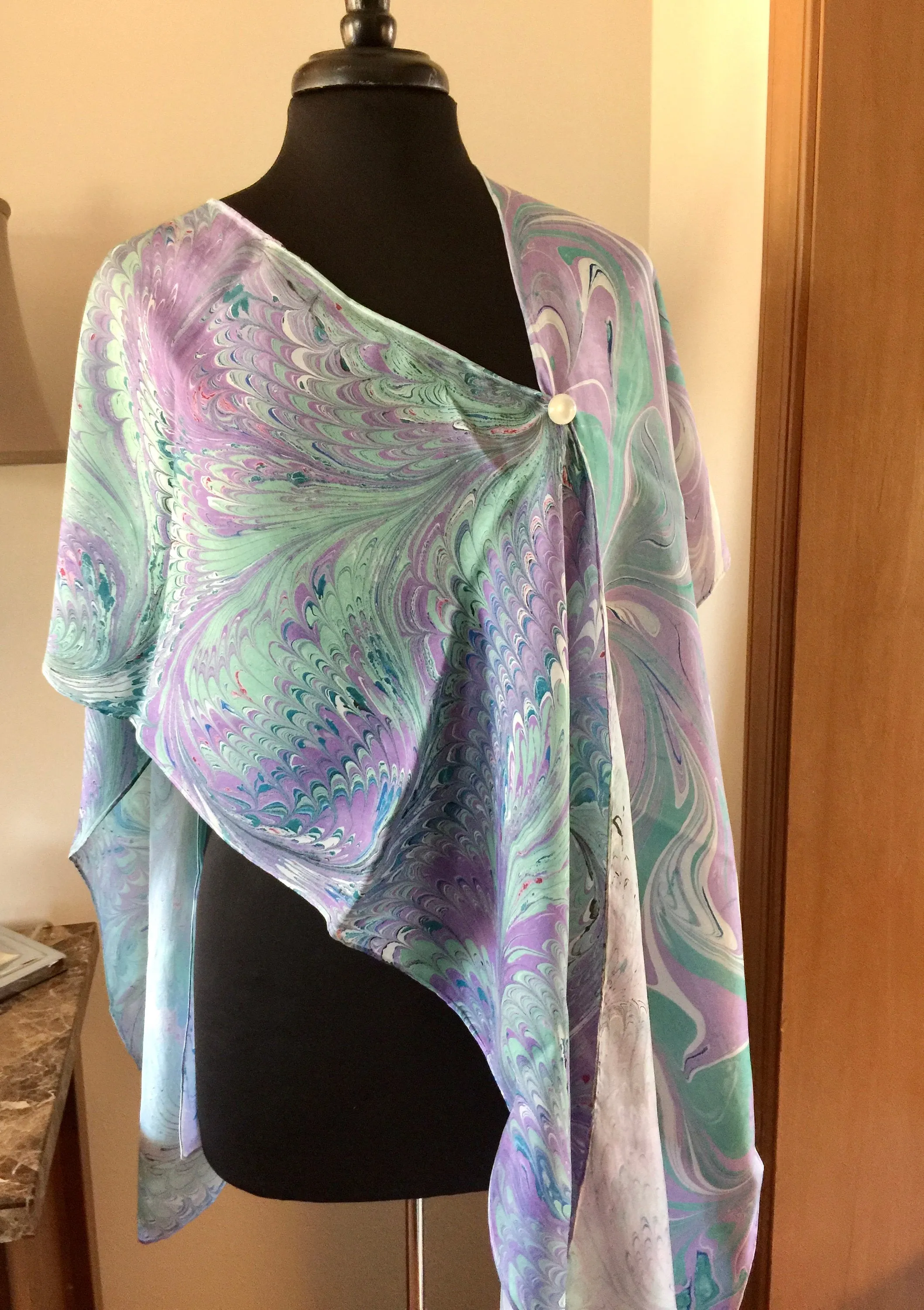 The Shibumi.  It’s a wrap, a shawl, a fashion statement!  Wear it 10 different ways!