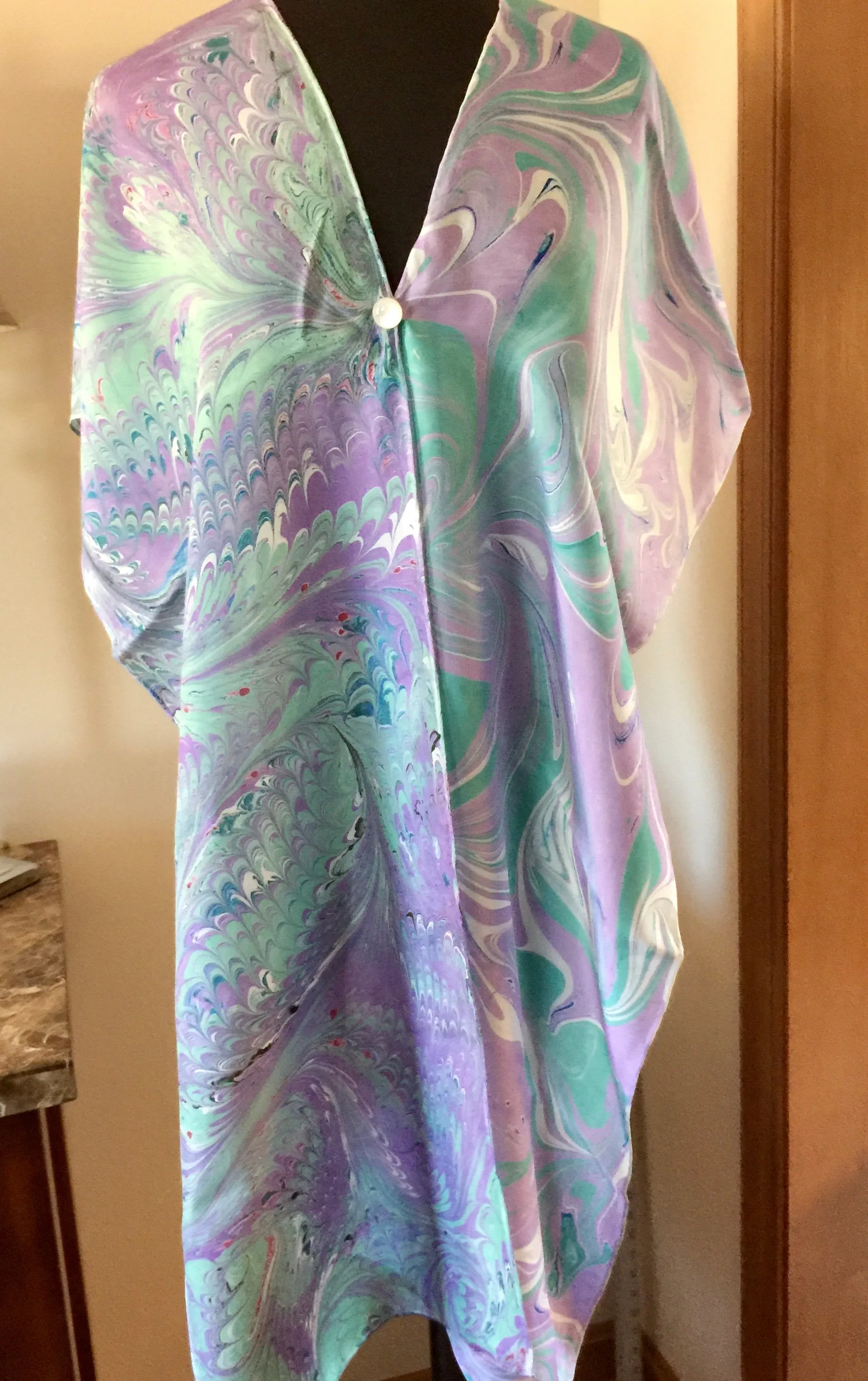 The Shibumi.  It’s a wrap, a shawl, a fashion statement!  Wear it 10 different ways!